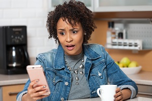 Woman shocked looking at phone 
